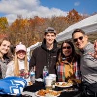 Five alums together at the tailgate.